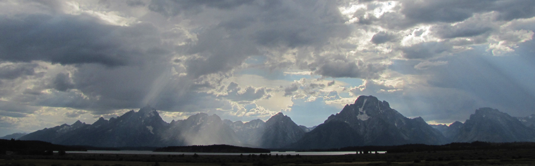Teton range with clouds and rays of sun